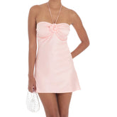 Pink halter dress worn by a model-front